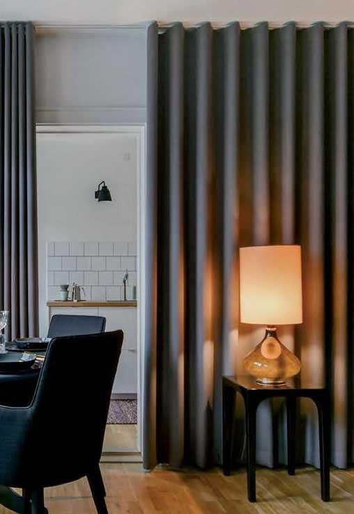 Silent Gliss Wave curtains in a modern living room showing the even wave pattern