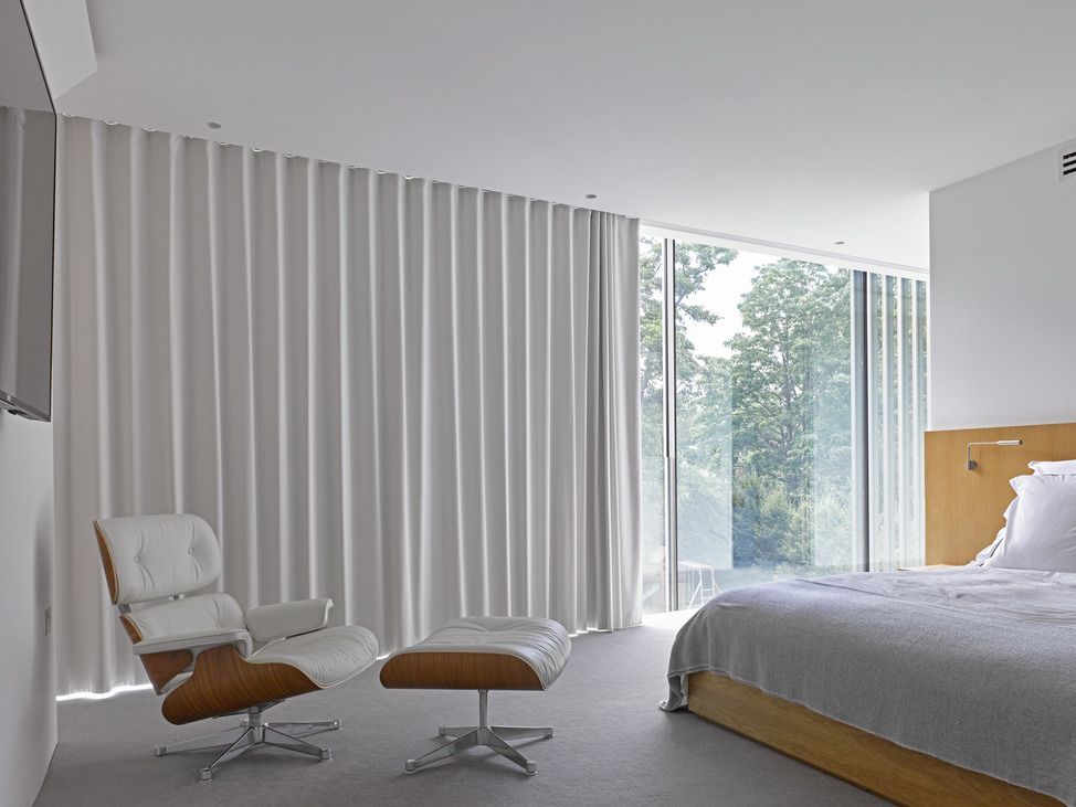 Bedroom with floor-to-ceiling Wave curtains on a curved 5600 track