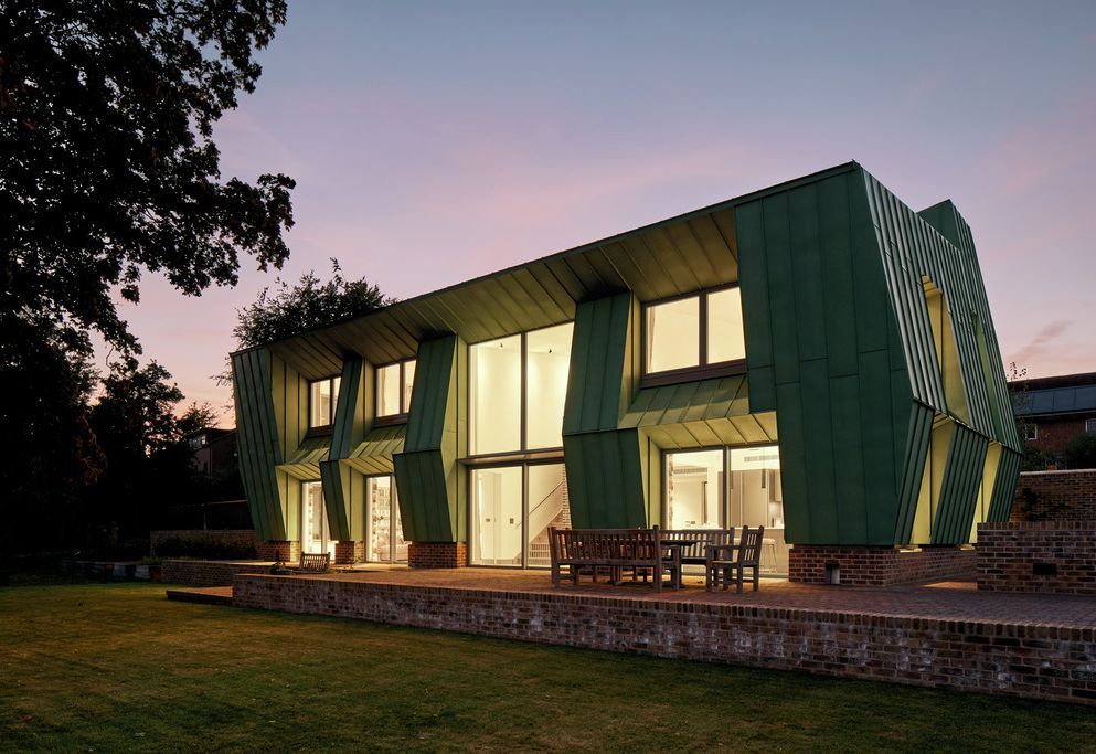 Copper Bottom exterior at dusk — folded copper cladding glowing against a pink sky
