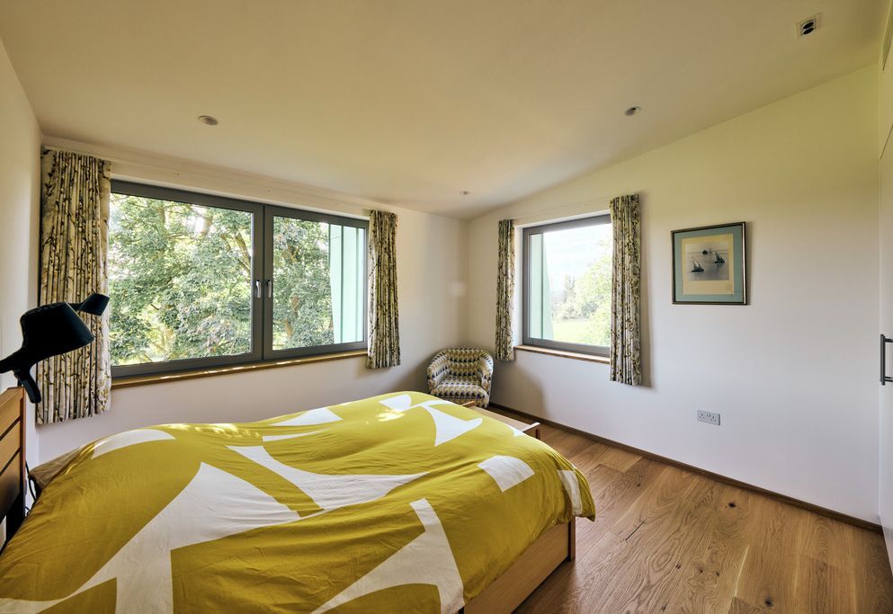 Bedroom with printed dim-out curtains and garden views