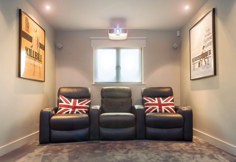 Home cinema with motorised roller blind on the window