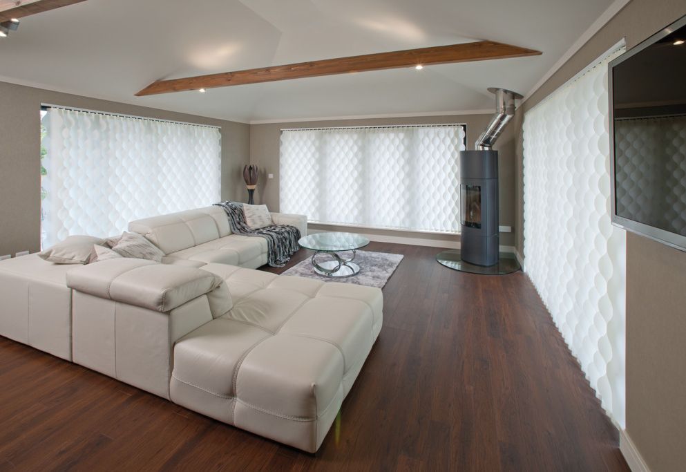 Living room with Vertical Wave curtains, log burner, and exposed beam