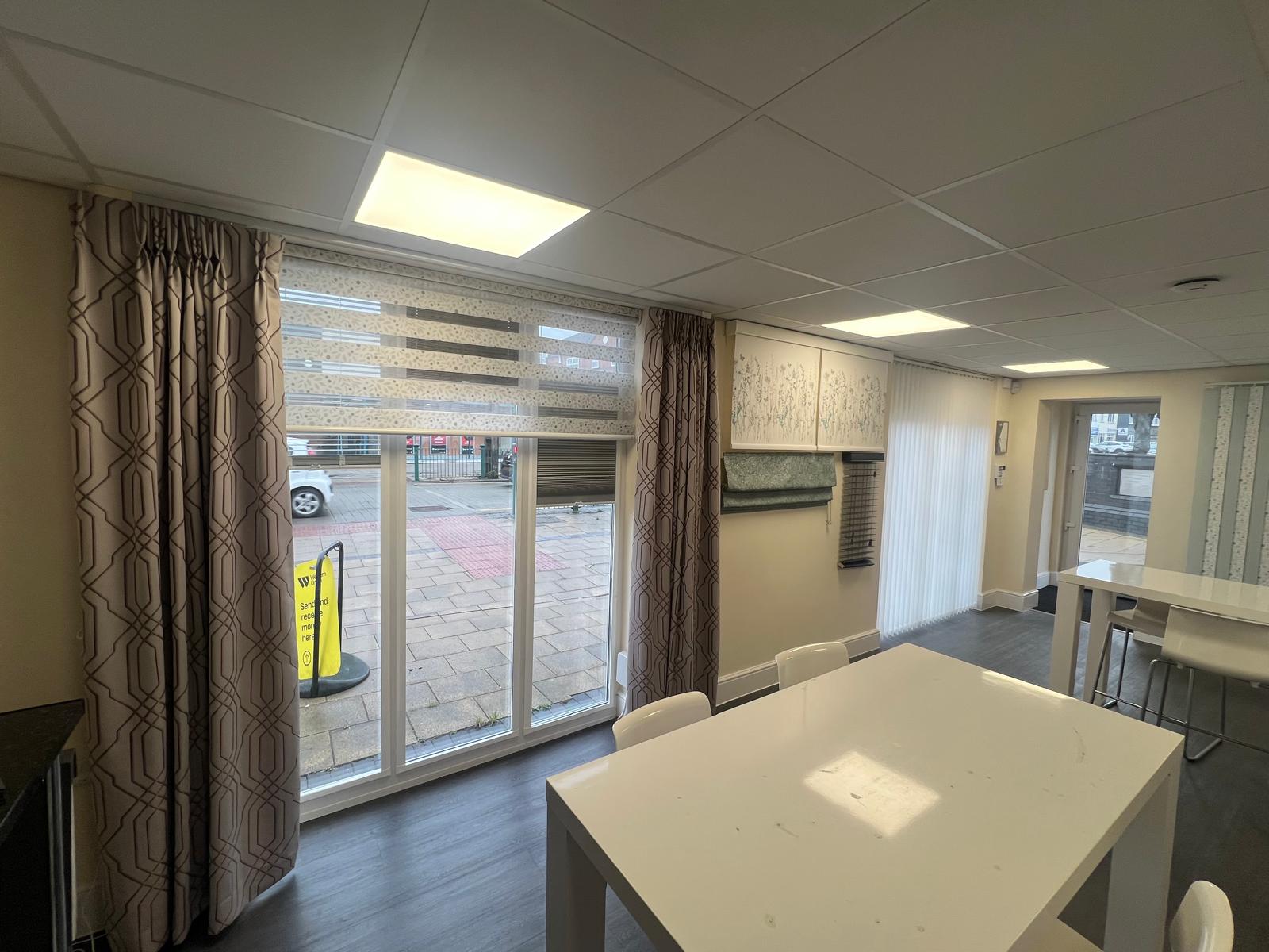 Showroom window display with electric curtains and vision blinds